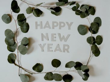 Happy New Year letters surrounded by Eucalyptus branches