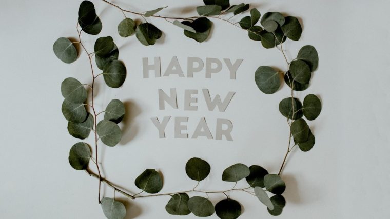 Happy New Year letters surrounded by Eucalyptus branches